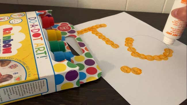 Box of Do A Dot markers with respective  colors visible, adjacent  to a expanse  with 