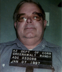 A person holding an Arizona Department of Corrections sign with the name "Randy Greenawalt," an inmate number, and a date