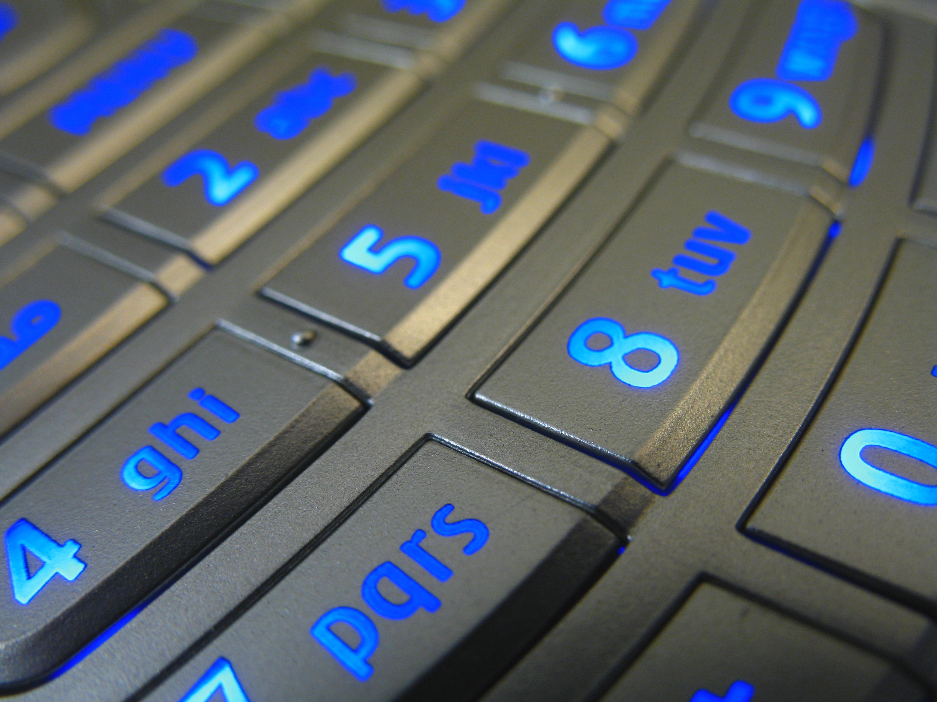 Close-up of a mobile telephone  keypad with illuminated numbers and letters