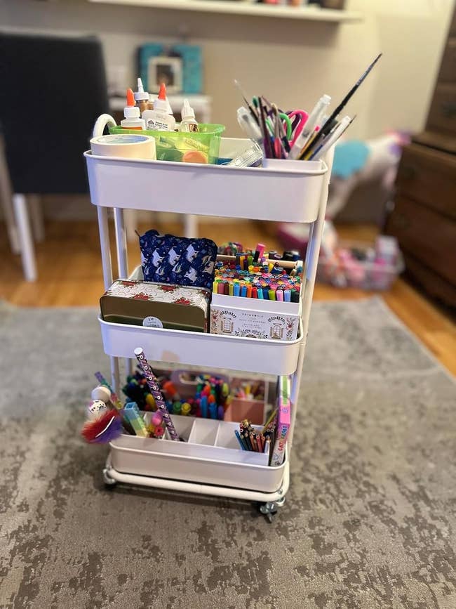 Rolling cart filled with creation  supplies similar  markers, brushes, and glue, organized connected  3  shelves. Ideal for originative  projects astatine  home