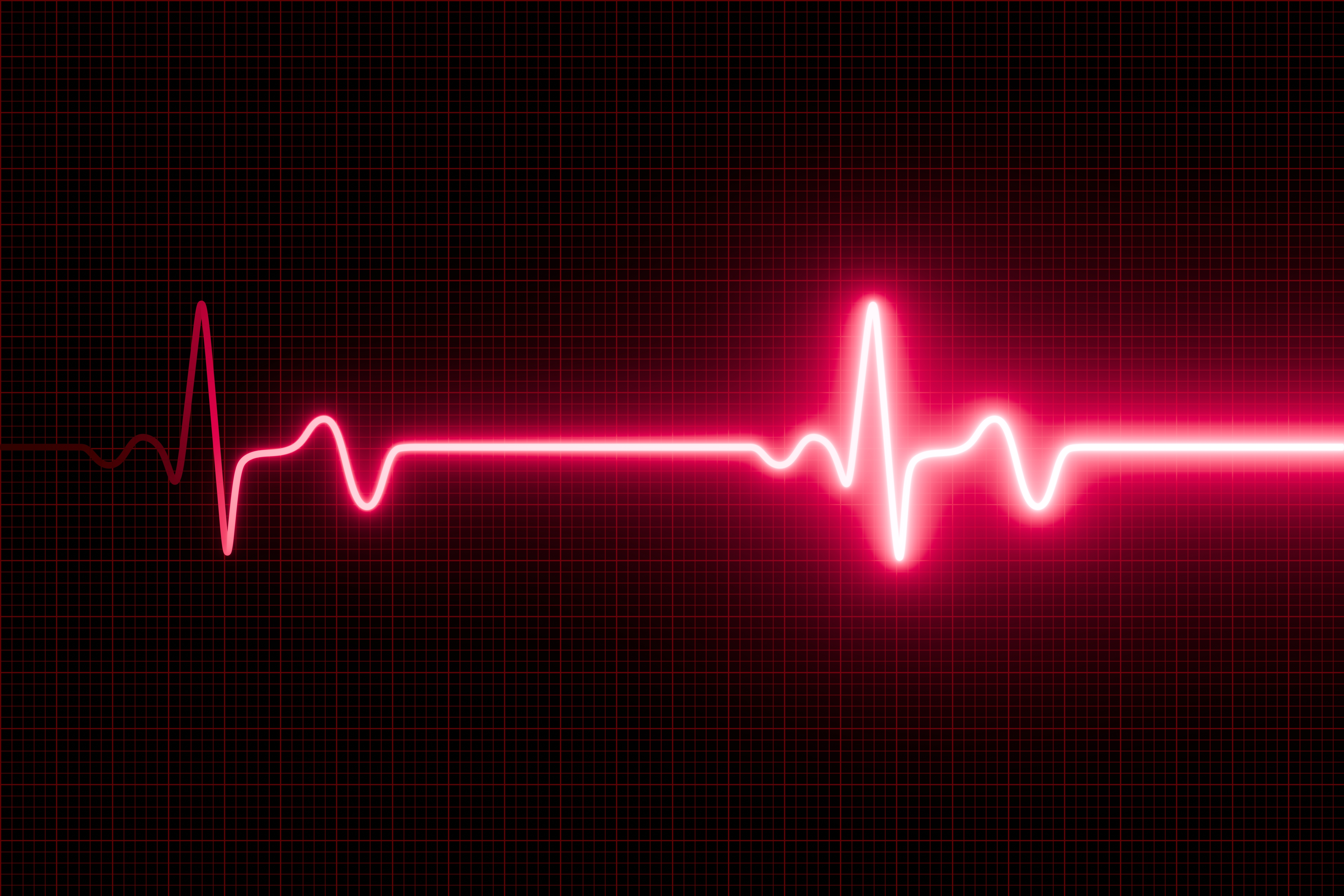 Heartbeat waveform on a graph, symbolizing life or vitality. The bright line represents a rhythmic heart pulse