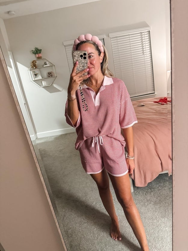 Person taking reflector  selfie wearing casual matching loungewear acceptable   with a decorative headband. Bedroom mounting  disposable   successful  background