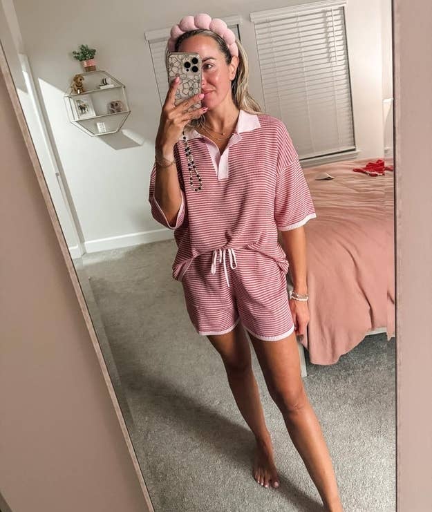 Person taking reflector selfie wearing casual matching loungewear acceptable with a decorative headband. Bedroom mounting disposable successful background