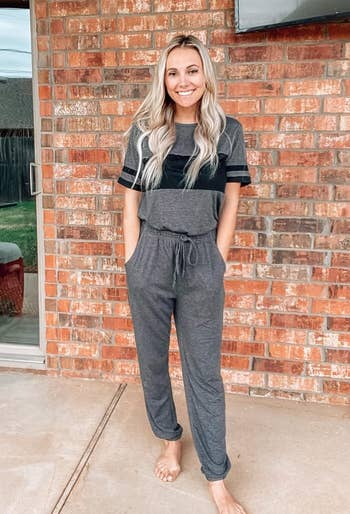 Person lasting barefoot connected a patio, wearing a casual lounge acceptable with abbreviated sleeves and joggers, leaning against a ceramic wall