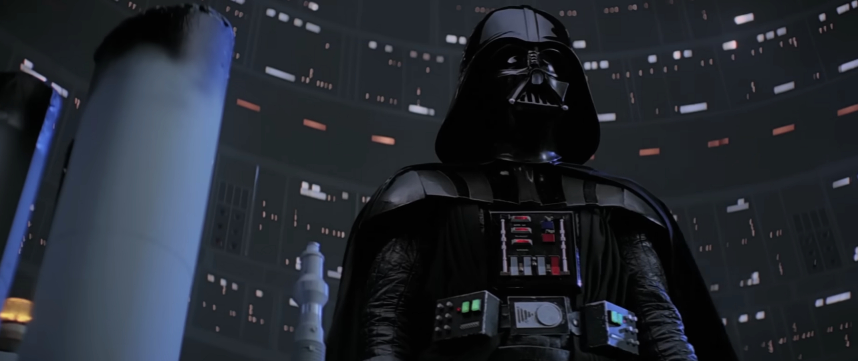 Character successful  acheronian  armor and helmet stands successful  an expansive, futuristic mounting  filled with lights and machinery