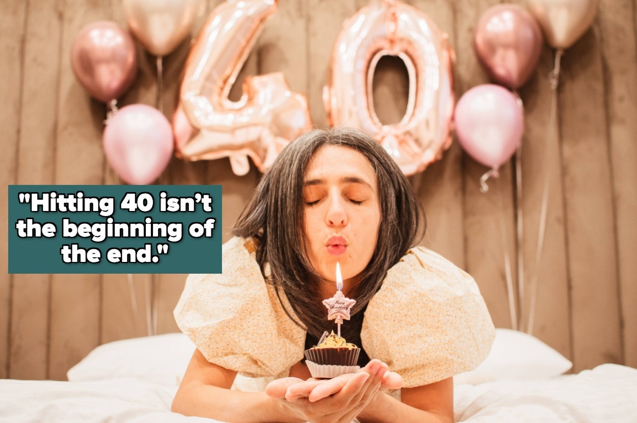 Woman blowing out candle on cupcake, celebrating 40th birthday in bed with balloon backdrop. Text: "Hitting 40 isn't the beginning of the end."