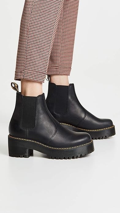 Person wearing stylish achromatic  level    Chelsea boots with textured pants