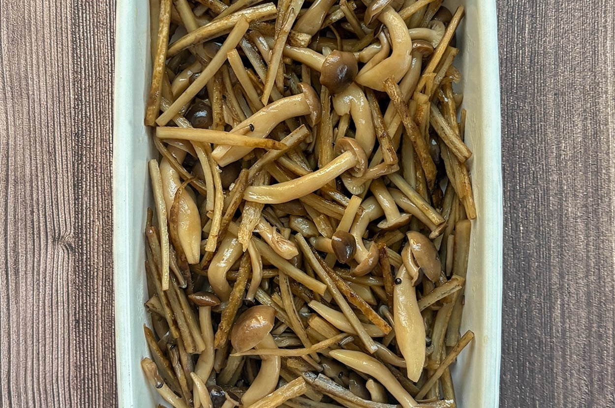 調理されたきのことごぼうのきんぴらが白い皿に盛られている。