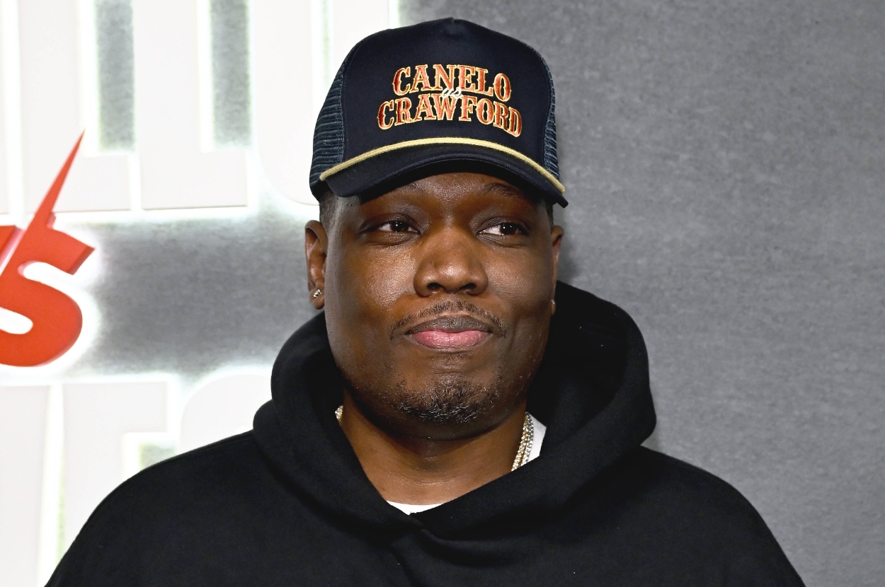 A person wearing a "Canelo Crawford" cap and a black hoodie stands against a background with some text