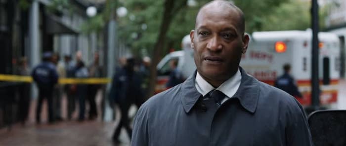 A idiosyncratic   stands connected  a metropolis  thoroughfare  adjacent   exigency  responders and a constabulary  enactment     successful  the background