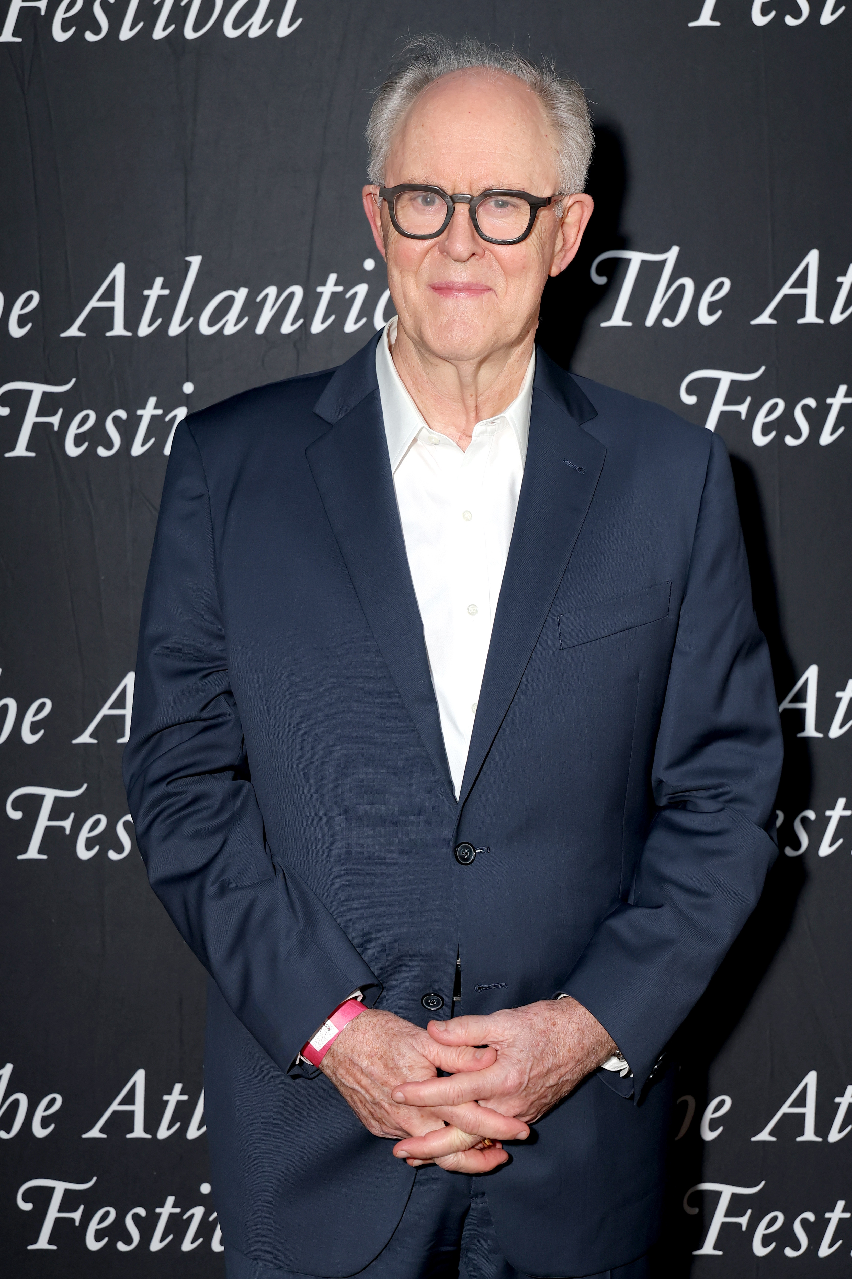 Person successful  a tailored suit   astatine  The Atlantic Festival, posing for the camera with a neutral expression