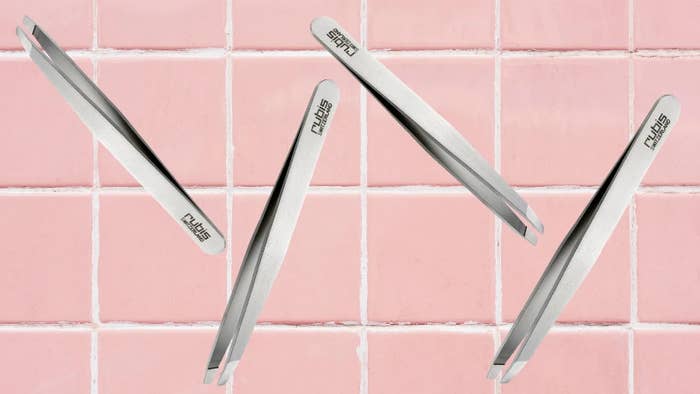 Several metallic  tweezers are arranged implicit    a tiled surface, showcasing their sleek plan  for a buying  article