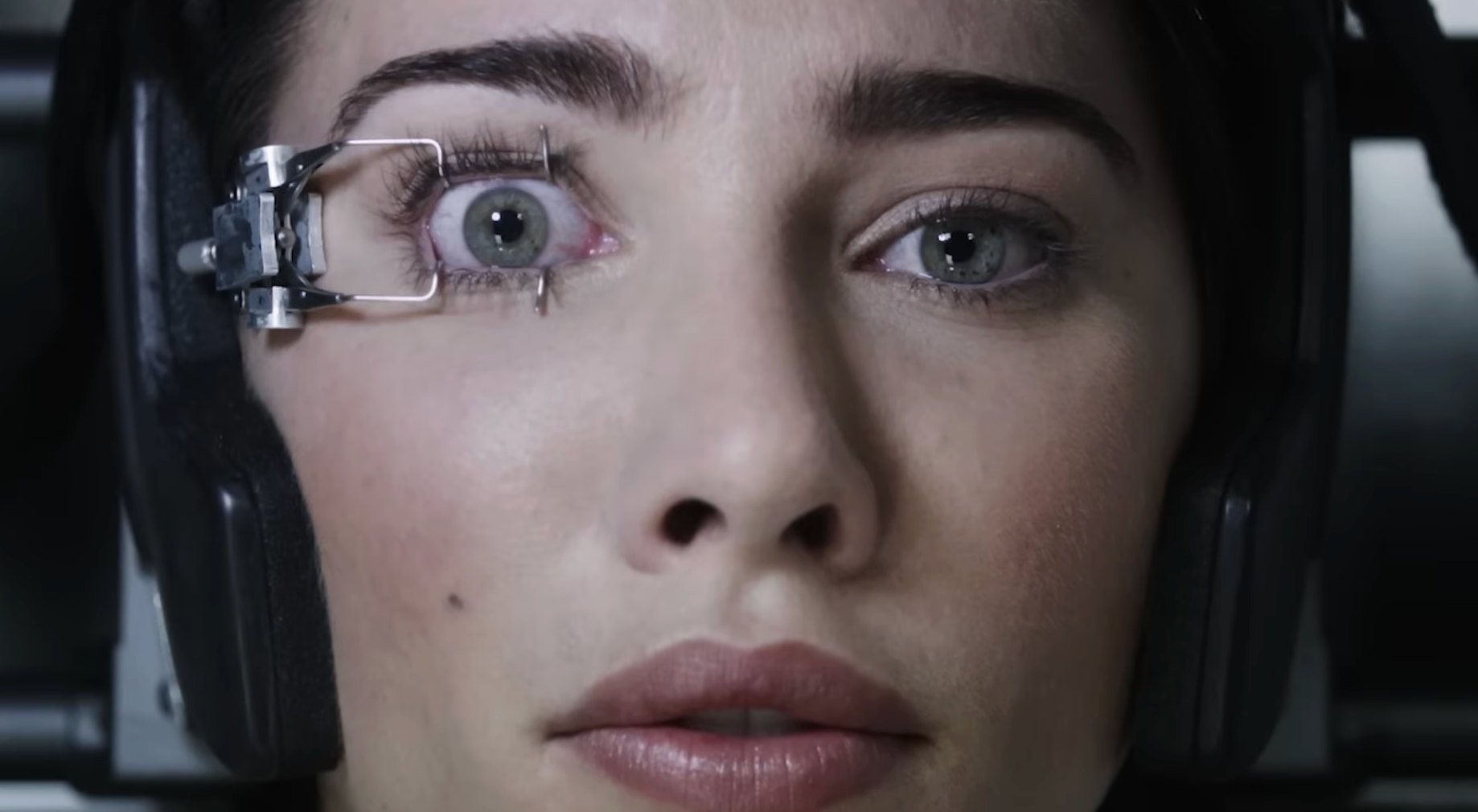 Person with a mechanical instrumentality  holding 1  oculus  open, appearing focused oregon  intense, perchance  successful  a sci-fi oregon  melodramatic  scene. 