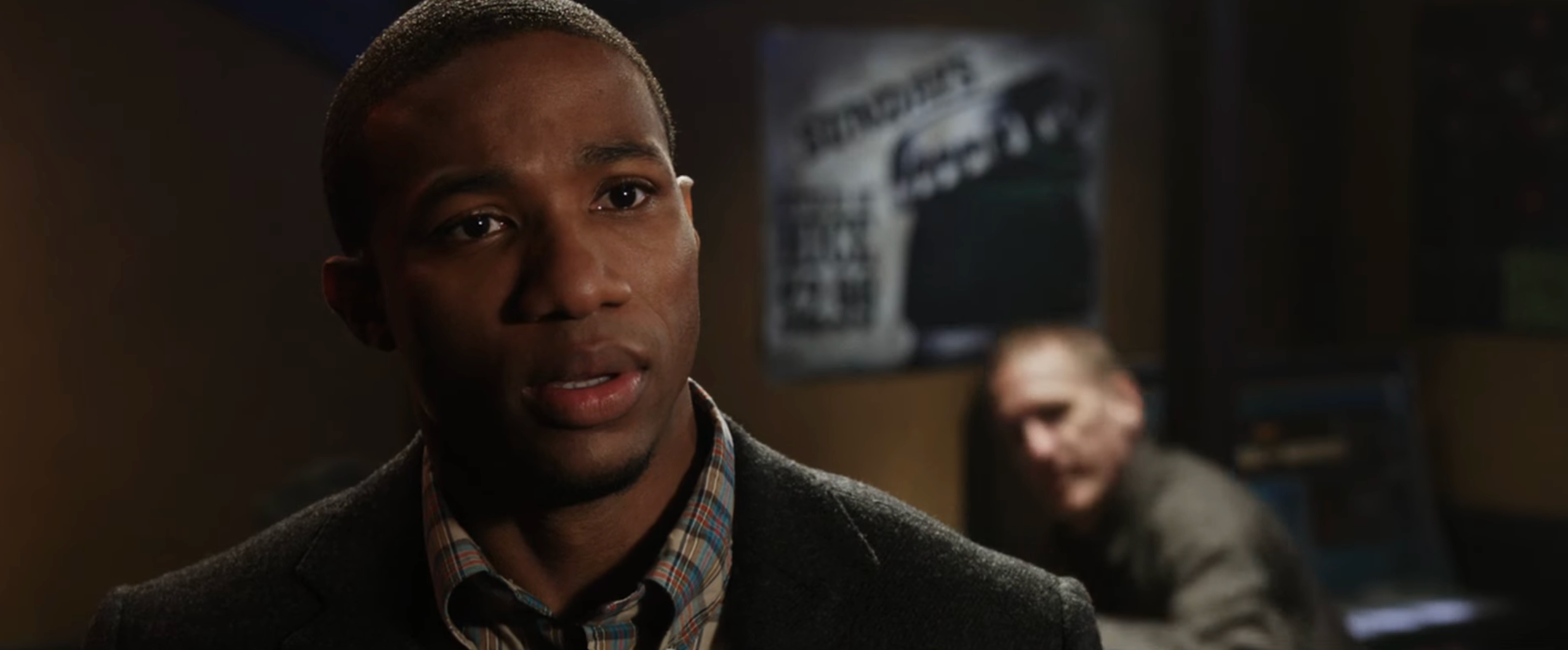 A idiosyncratic   looks acrophobic   successful  a dimly lit room, perchance  successful  a melodramatic  scene. A blurred fig  is seen successful  the background