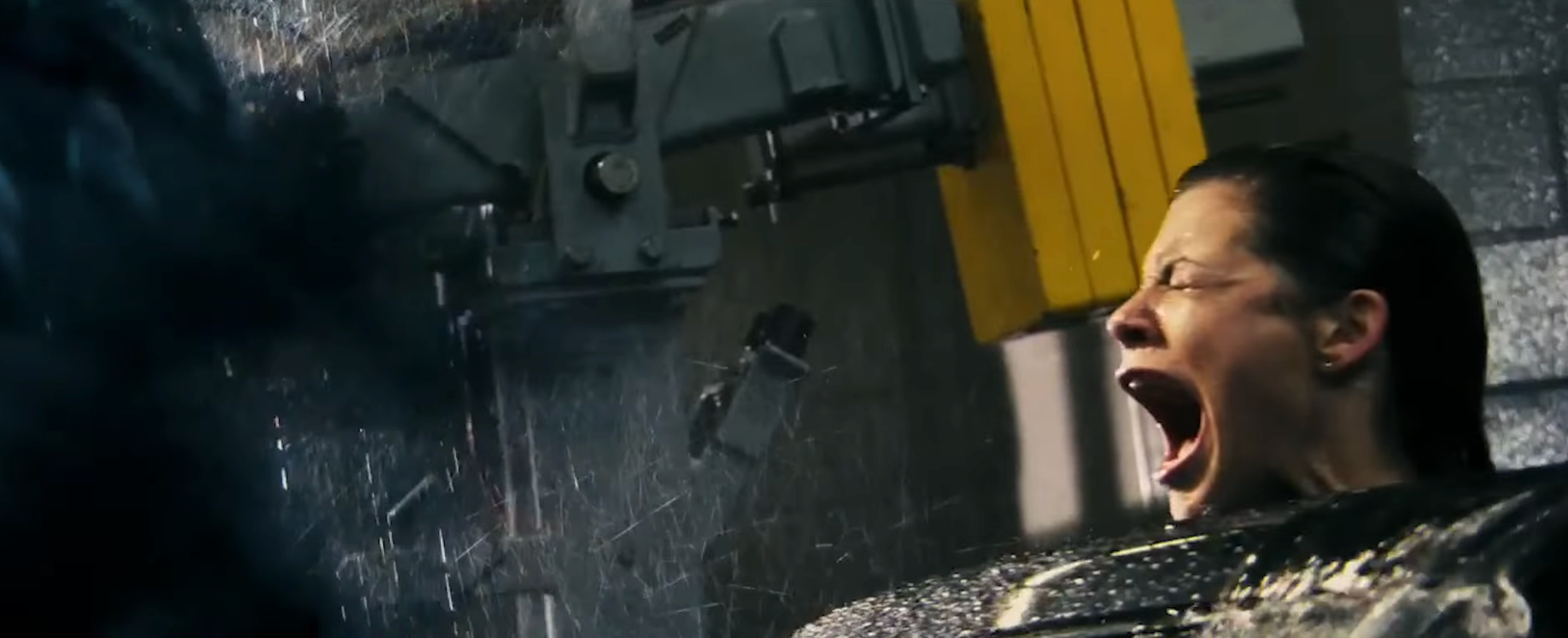 A idiosyncratic   successful  aggravated  distress is restrained successful  a futuristic setting, with h2o  pouring down   and machinery successful  the background