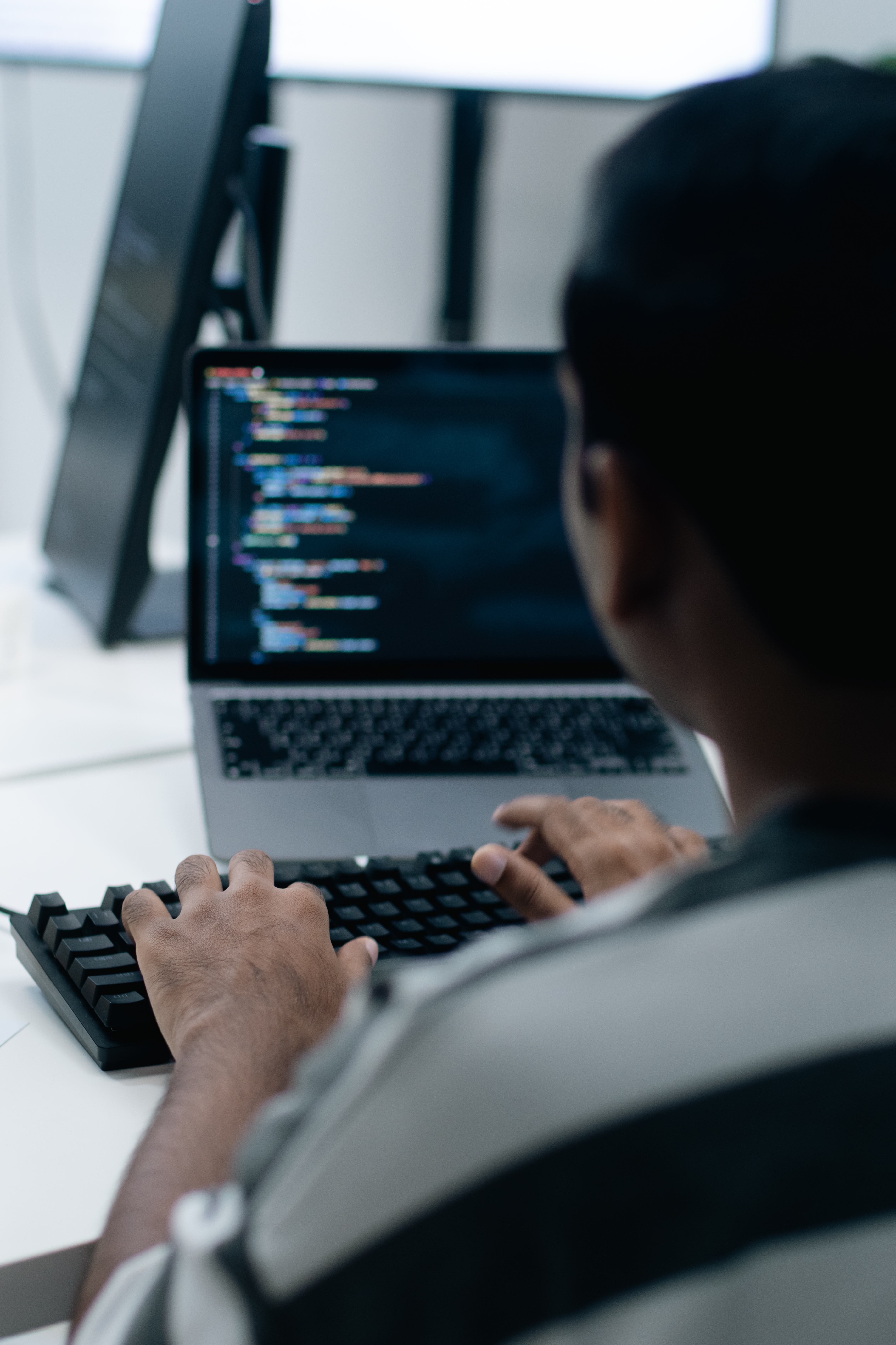 Person typing codification  connected  a laptop astatine  a workstation, focusing connected  a programming task