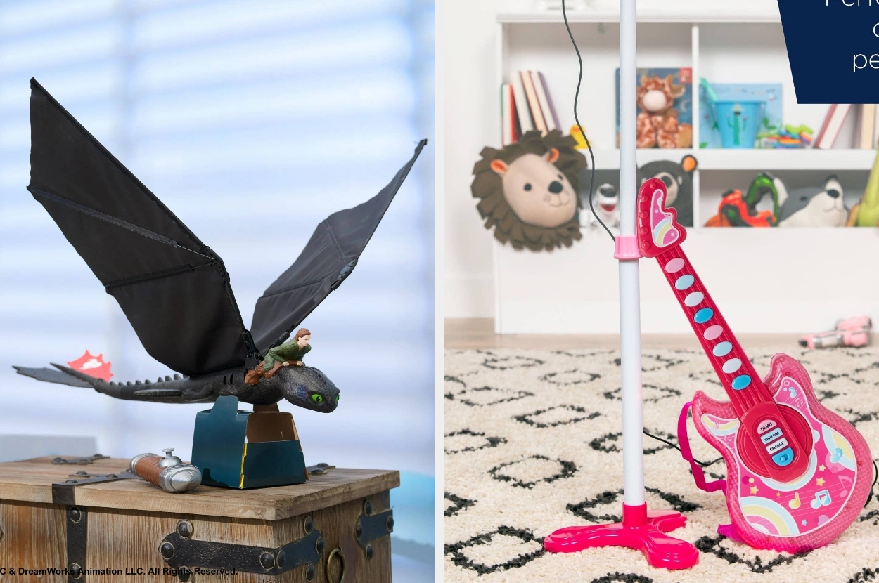 Toy dragon on a wooden box and a pink toy guitar with mic stand, set in a child's playroom with colorful decor