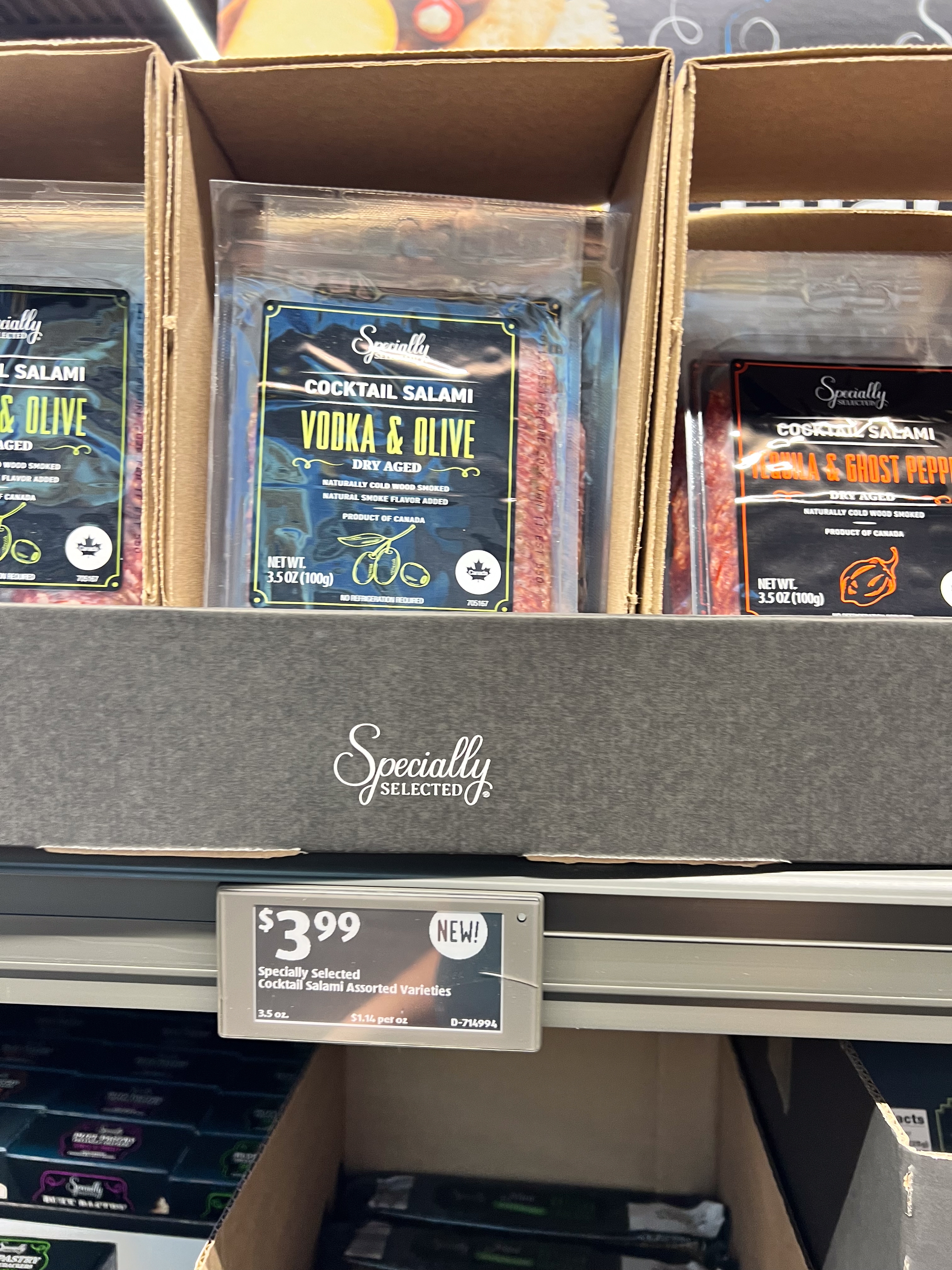 Salami packages displayed on a supermarket shelf, labeled &quot;Vodka &amp;amp; Olive&quot; and &quot;Ghost Pepper,&quot; priced at $3.99 each