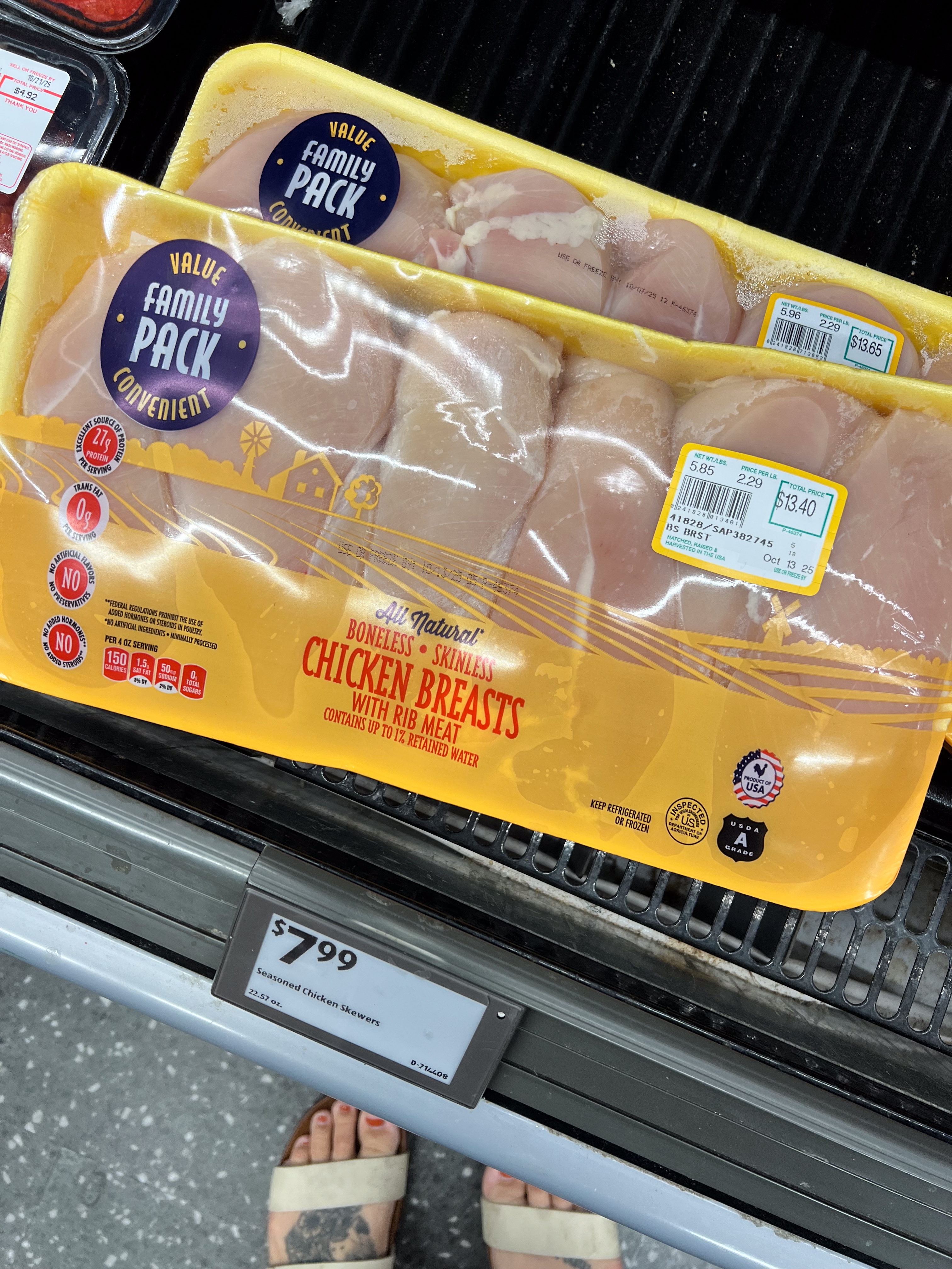 Packaged chicken breasts labeled as boneless and skinless, priced at $7.99. The packaging marked as a &quot;Value Family Pack.&quot;