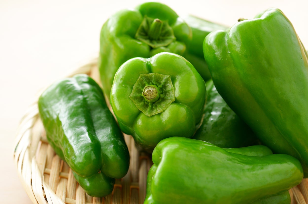 ざるに盛られた数個の緑のピーマン。