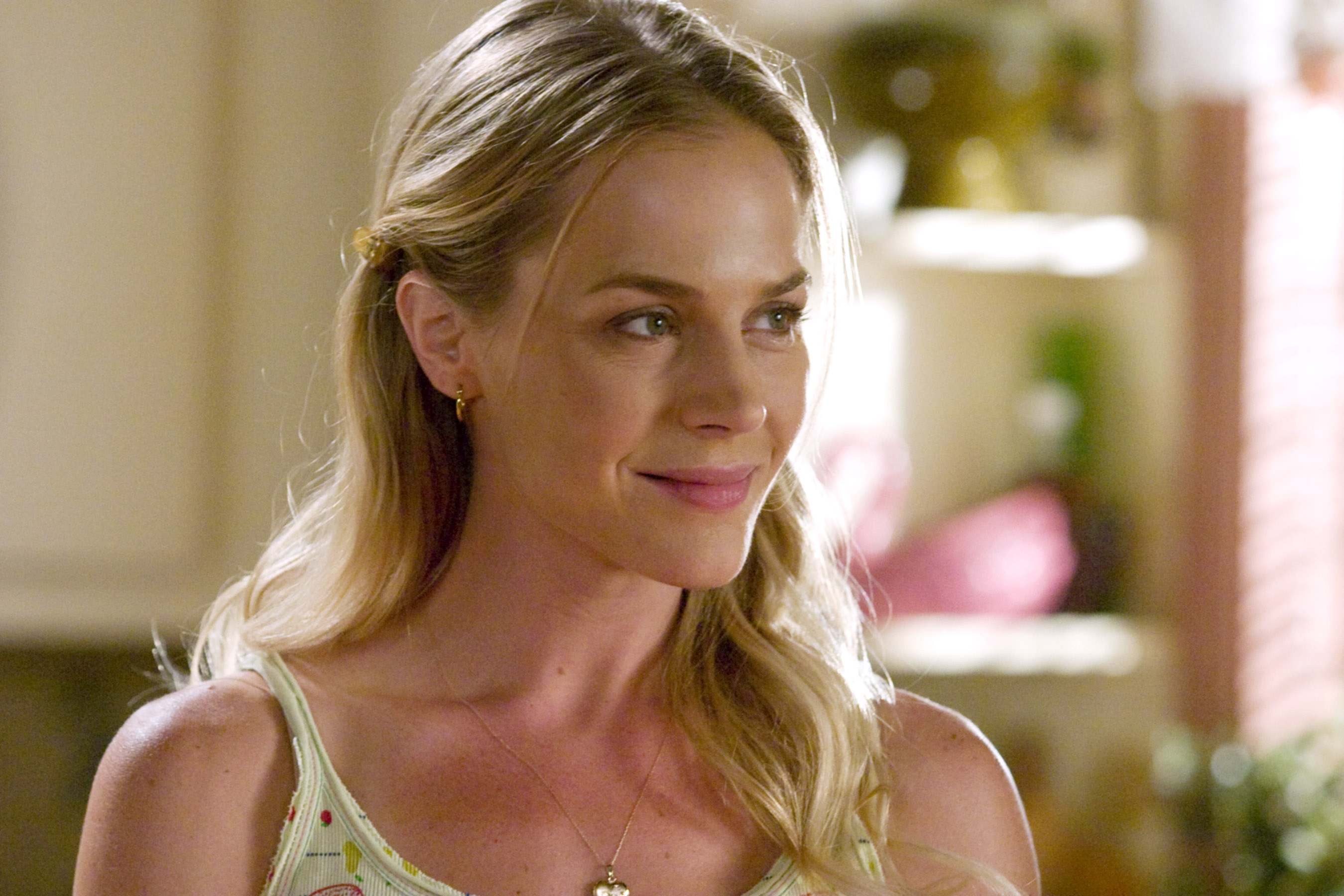 Person smiling successful  a location  setting, wearing a light, casual apical  with delicate patterns, hairsbreadth  styled simply