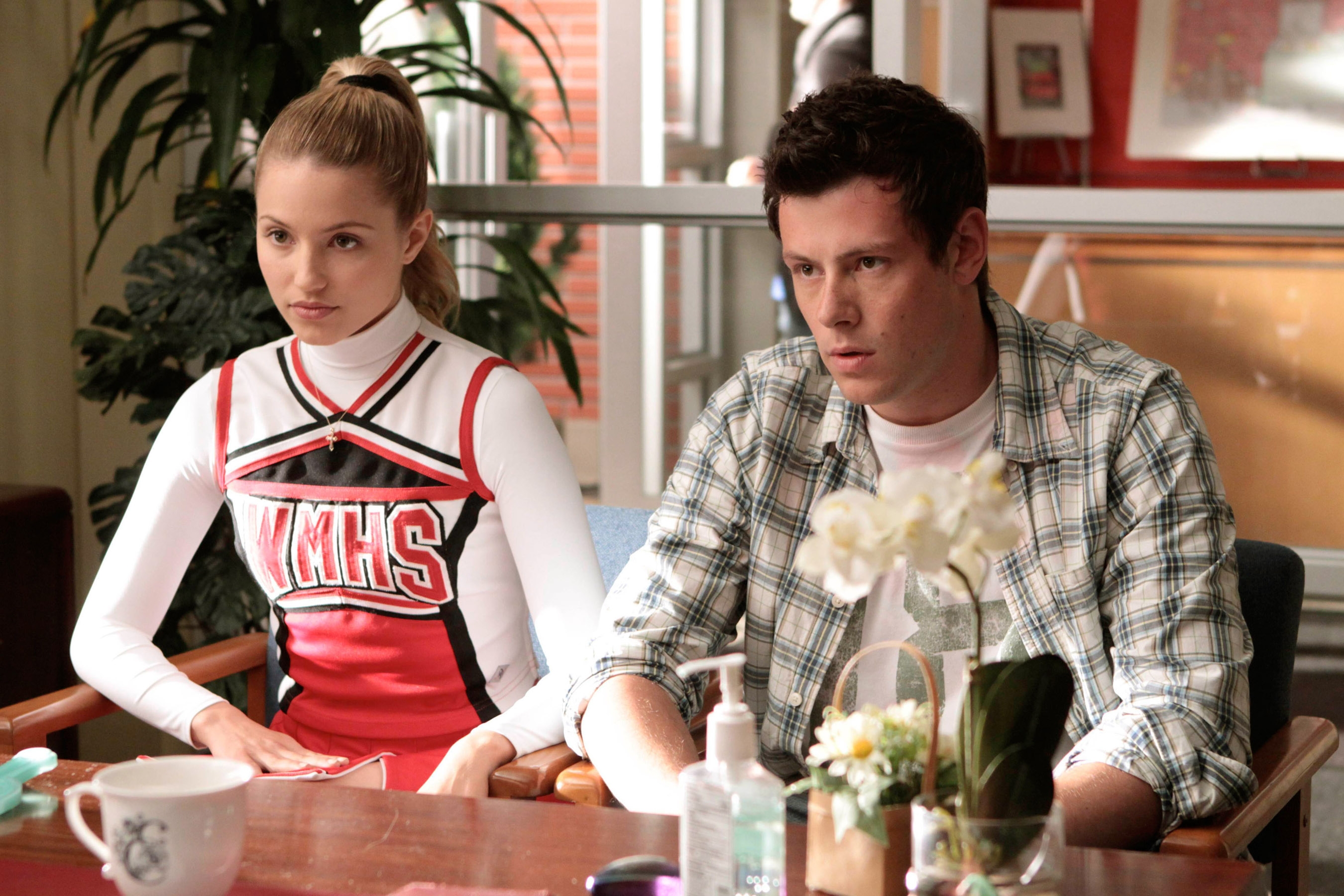 Two characters beryllium   astatine  a table; 1  successful  a cheerleader uniform, the different   successful  a plaid shirt, appearing serious, from a TV amusement   scene