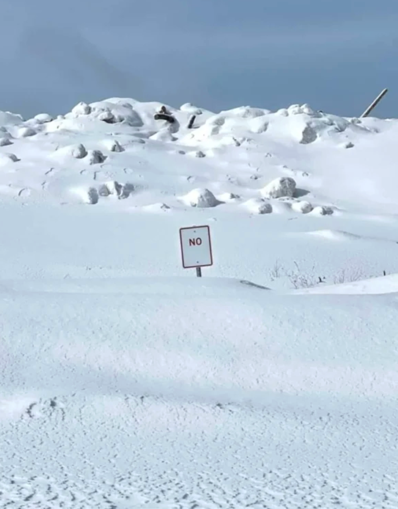 A tiny  motion   with the connection     "NO" is surrounded by a vast, snowy scenery  and snow-covered hills