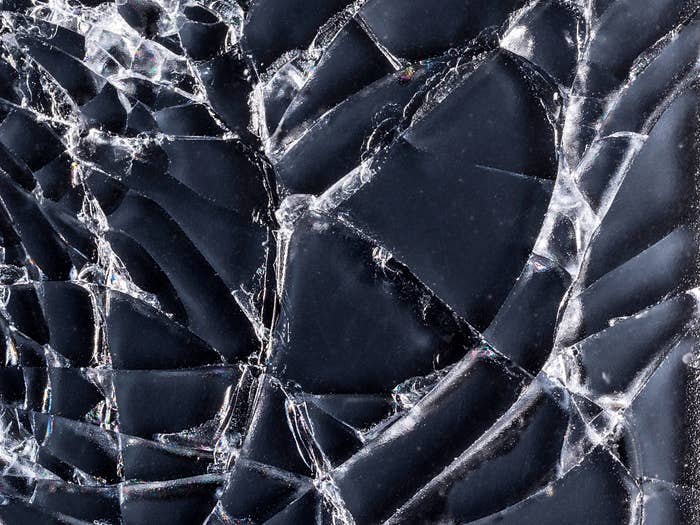 Close-up of shattered solid  with intricate cracks forming assorted  abstract patterns
