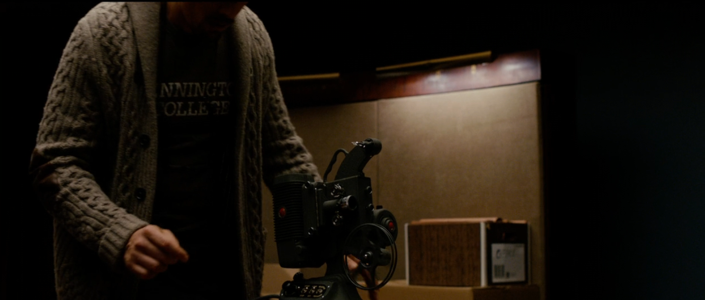 Person mounting  up   a nonrecreational  video camera successful  a dimly lit room, wearing a cardigan