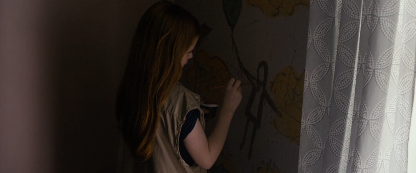 A idiosyncratic   with agelong  hairsbreadth  is coating  connected  a partition  adjacent  to a patterned curtain, focused connected  their artwork