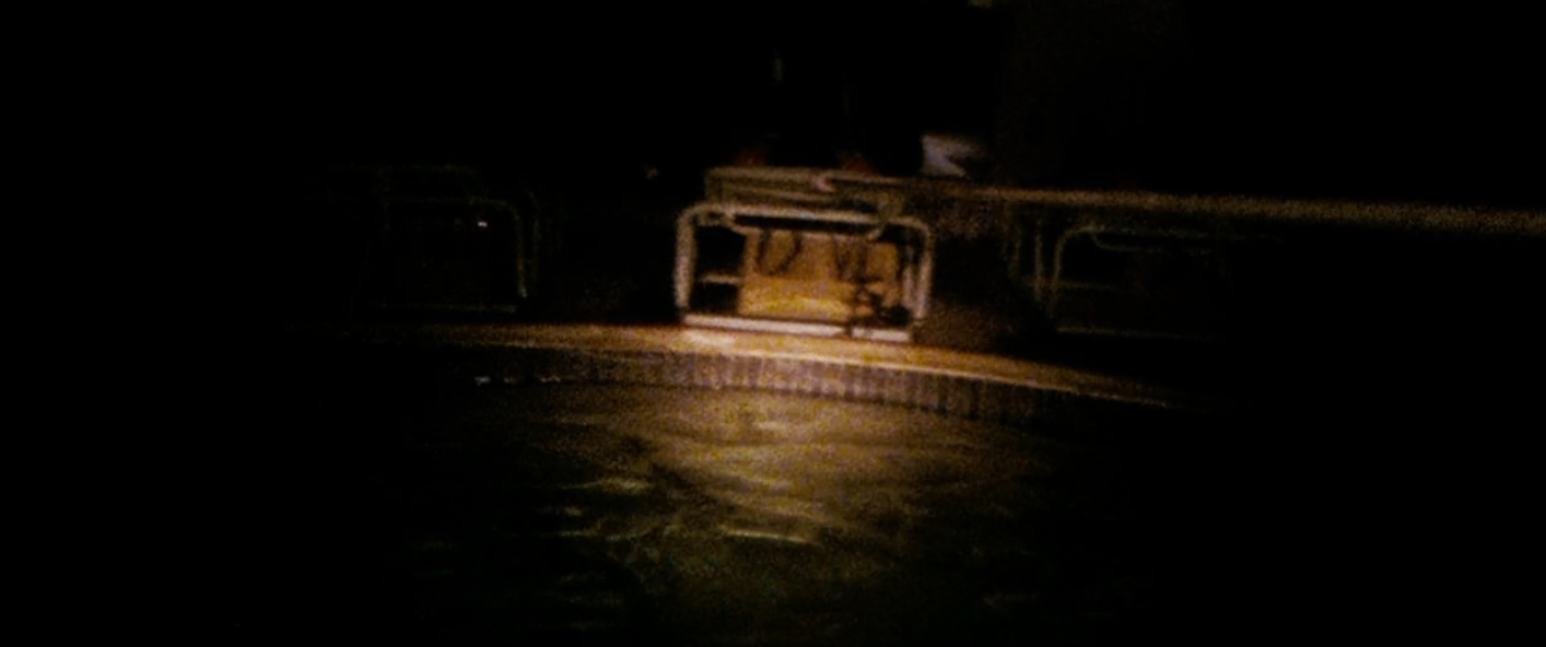 Dimly lit country   showing a circular swimming excavation  astatine  night