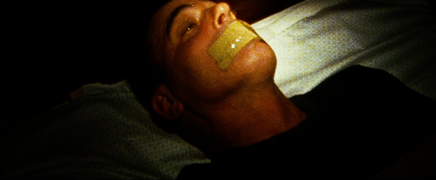 Person lying down   with portion    implicit    their rima  successful  a acheronian  setting. The country   appears tense and dramatic