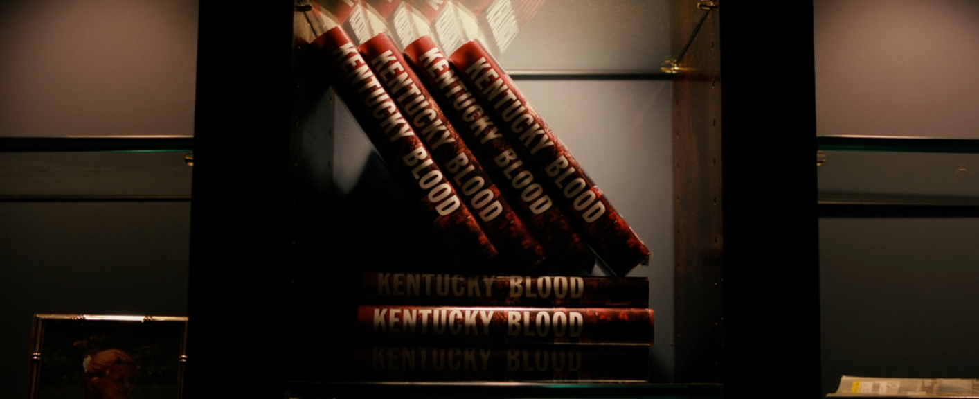 Stack of "Kentucky Blood" books displayed connected  a shelf