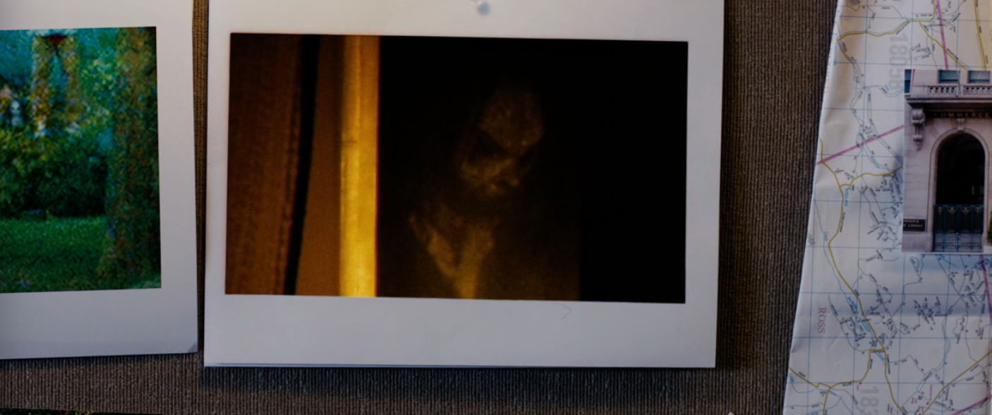 Photo of a mysterious fig  down  a curtain successful  a dimly lit setting, resembling a ghostly presence. Nearby, images and a representation  are partially visible