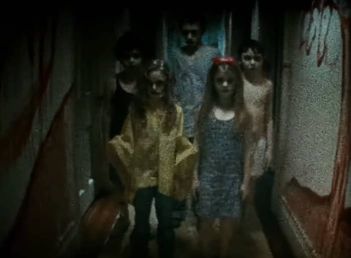 A radical  of children successful  ominous hallway with walls marked by red, apt  from a fearfulness   movie  scene