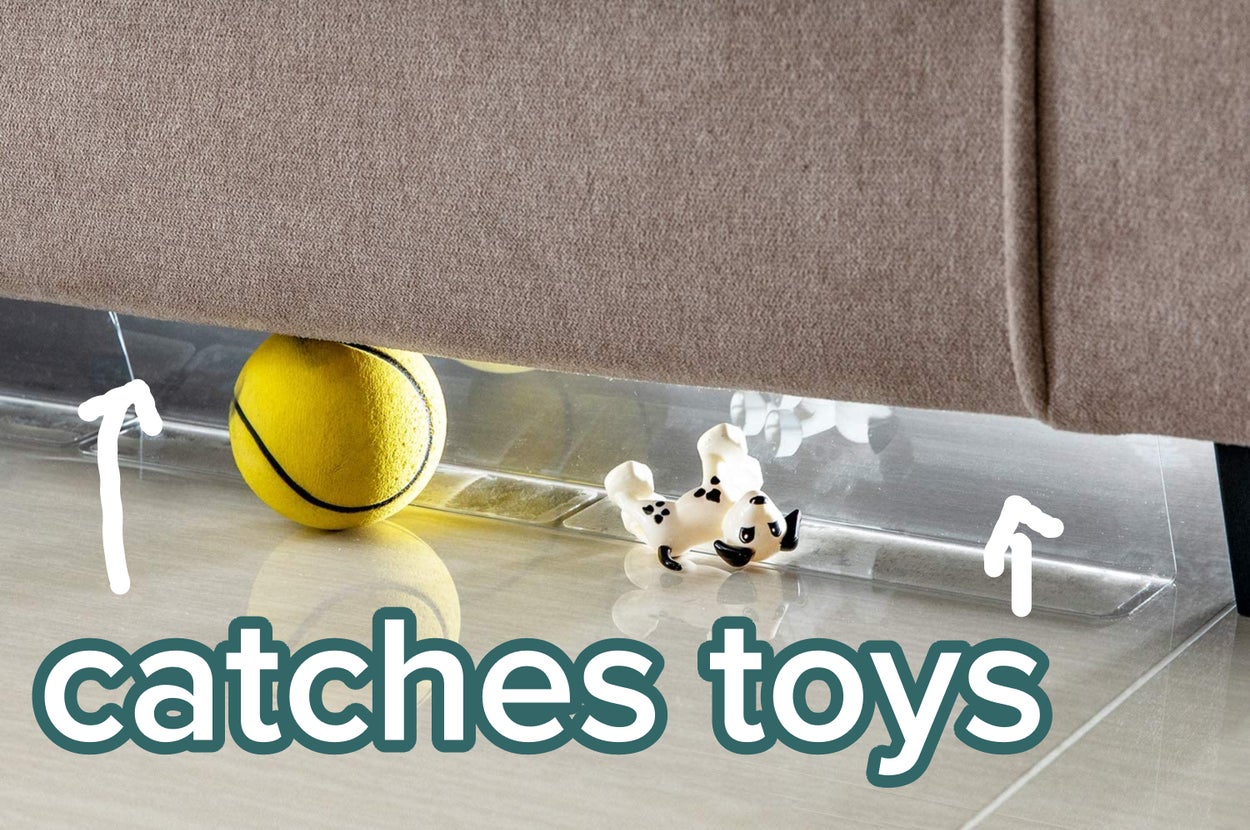 The toy blocker under a piece of furniture blocking a ball and stuffed animal