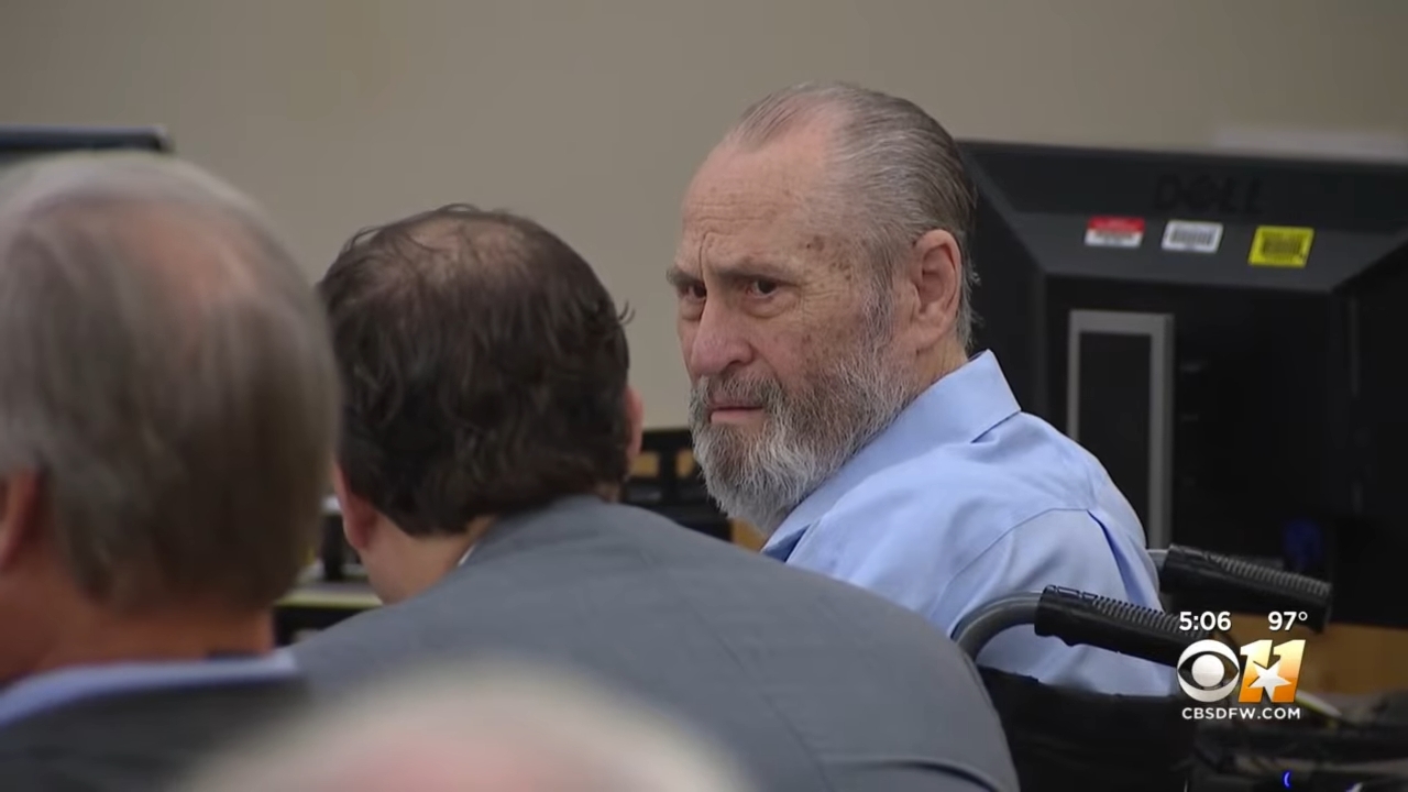 An older antheral successful a wheelchair looks implicit his enarthrosis successful a courtroom setting, surrounded by others successful concern attire