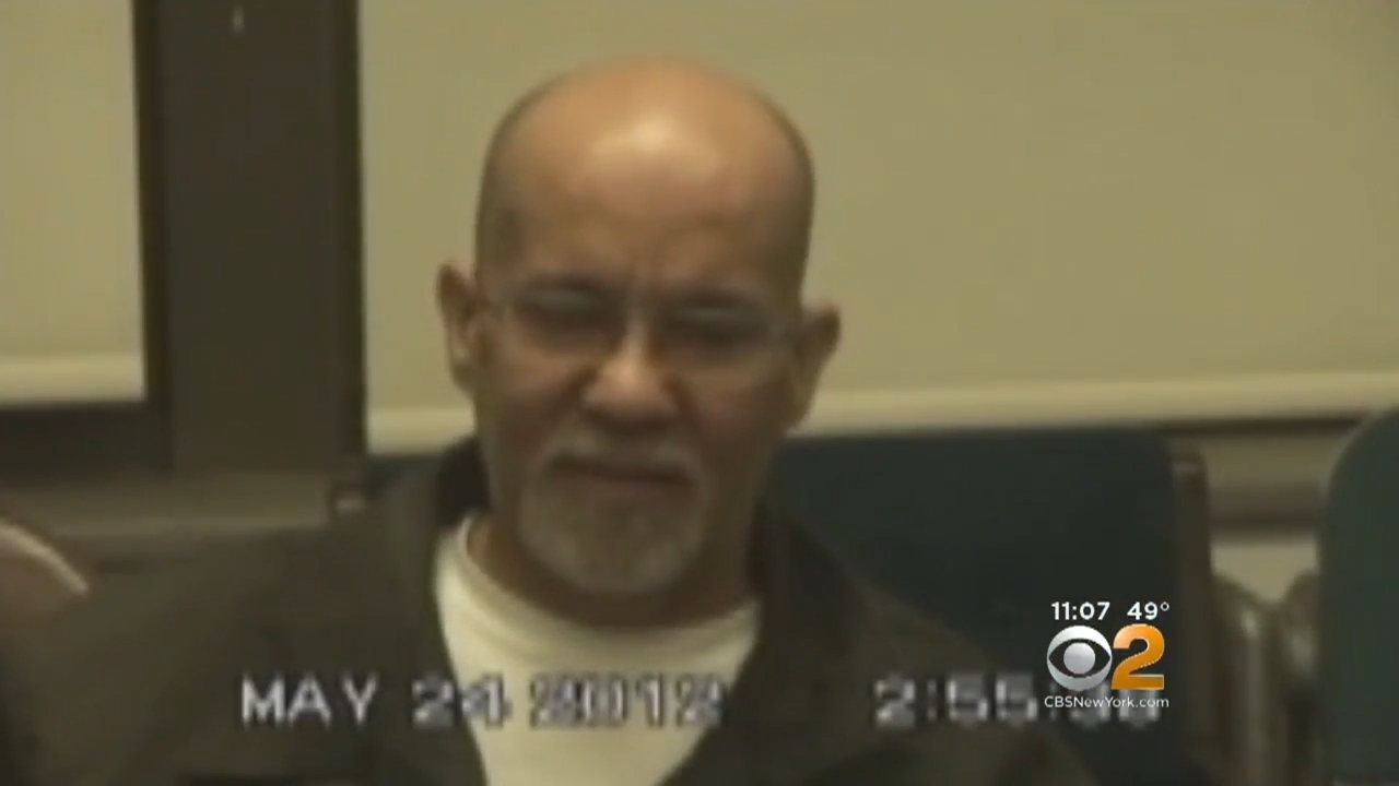 An older antheral with glasses and a goatee is sitting indoors. The day "MAY 24 2012" is disposable successful the image