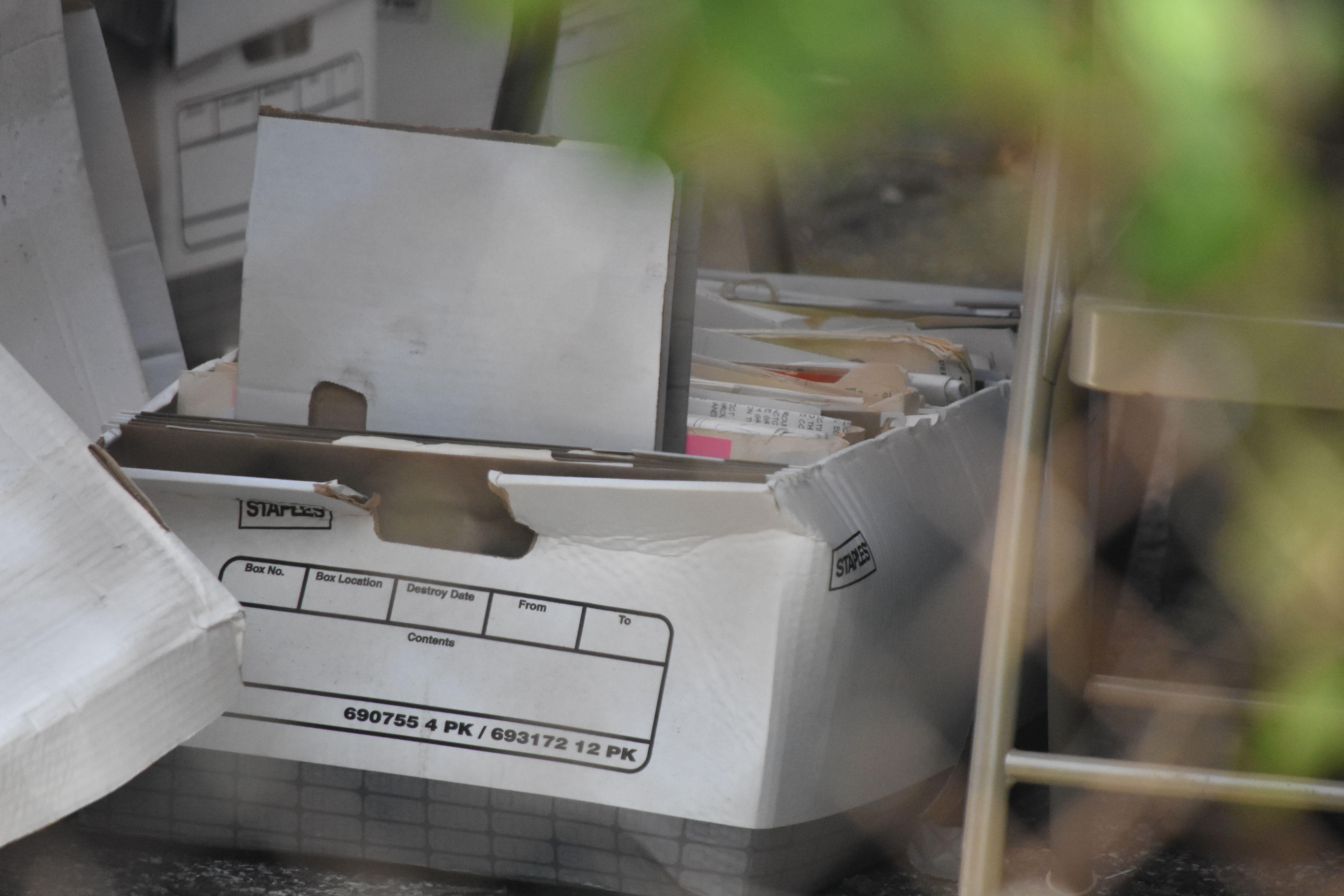 Partially opened container filled with files and folders, labeled with numbers and text