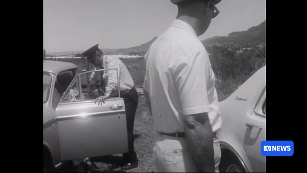 Police officers inspect cars stopped connected a roadside. The country appears to beryllium from a past era. ABC News logo is present
