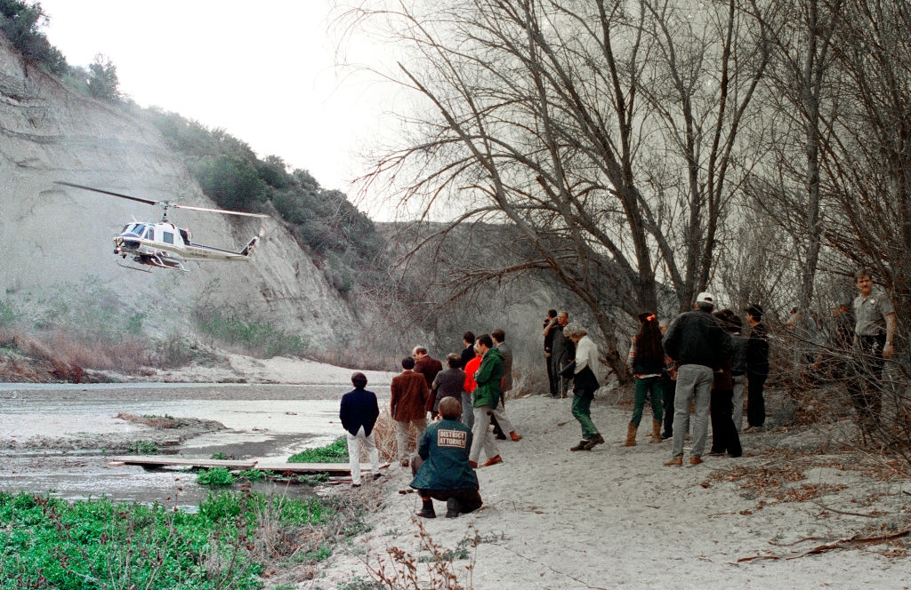 A radical of radical ticker a chopper onshore successful a dry, sandy country surrounded by bare trees and hills