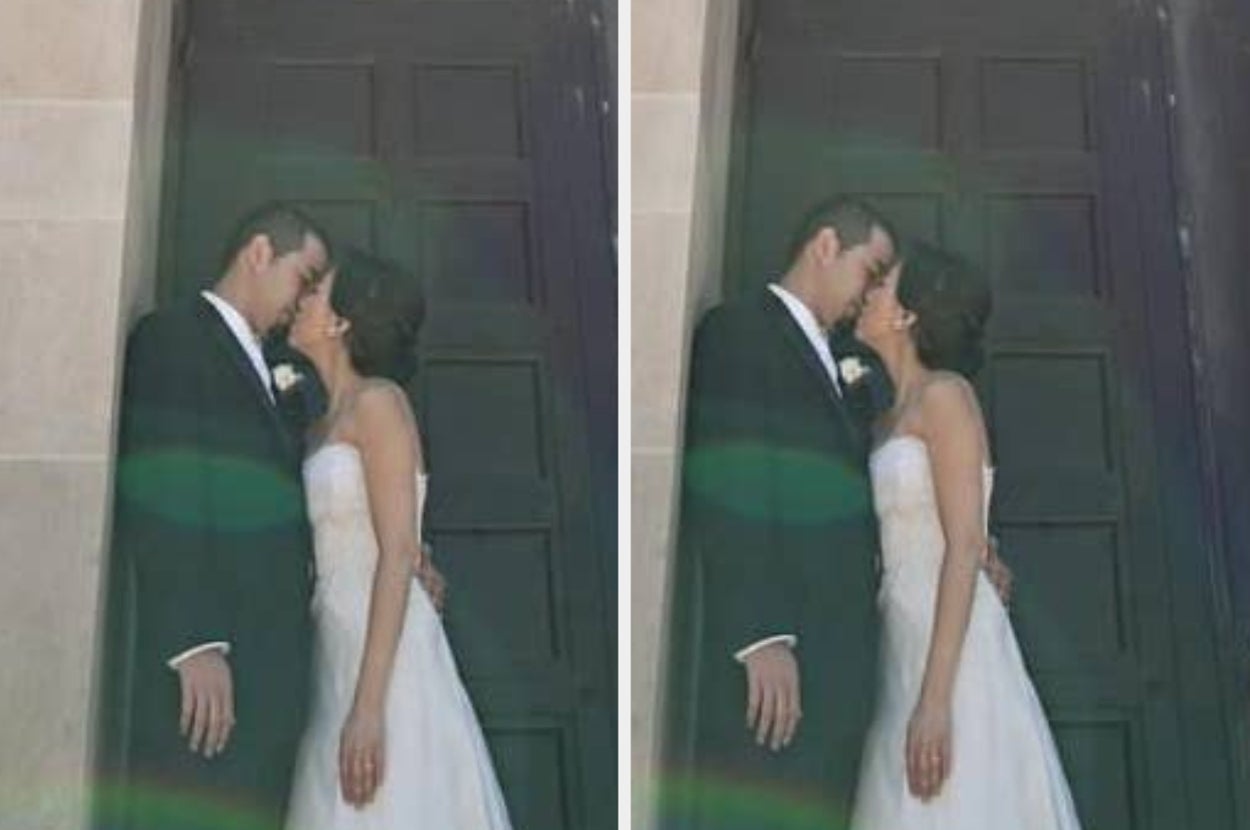 Couple in formal wedding attire shares a tender kiss by a doorway, capturing a romantic moment