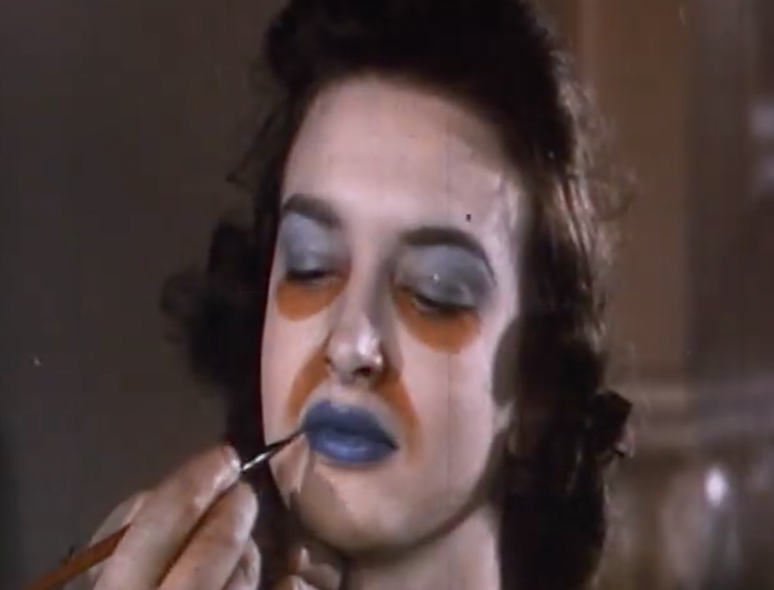 Person applying exaggerated constitution  to a woman's face, giving a theatrical oregon  creator  look, for a diagnostic   successful  a Rewind class  article