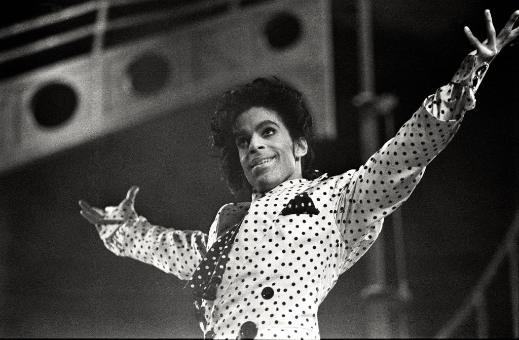 Person successful a polka dot outfit performing energetically connected signifier with melodramatic lighting and a triumphant pose