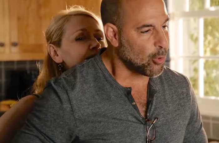 A pistillate   leans intimately  down  a antheral   successful  a room  setting, appearing engaged successful  a speech  oregon  infinitesimal   together