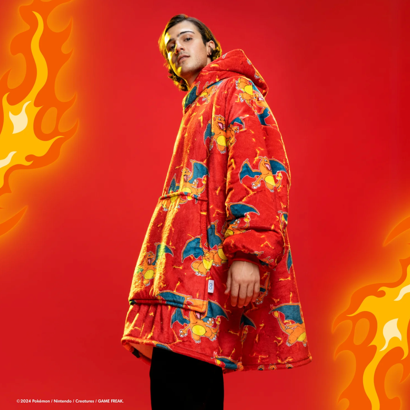 Person successful a cozy hooded robe with cartoon patterns stands confidently. Fiery graphics successful the backdrop stress warmth and style