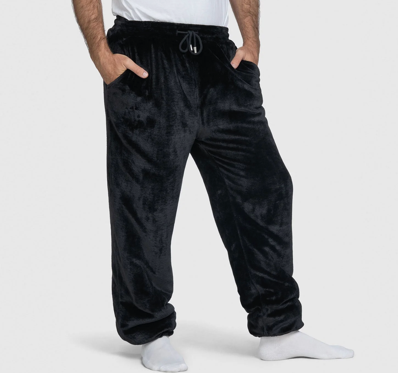 Person wearing plush, loose-fitting lounge pants with hands successful pockets. Ideal for cozy, relaxed indoor wear