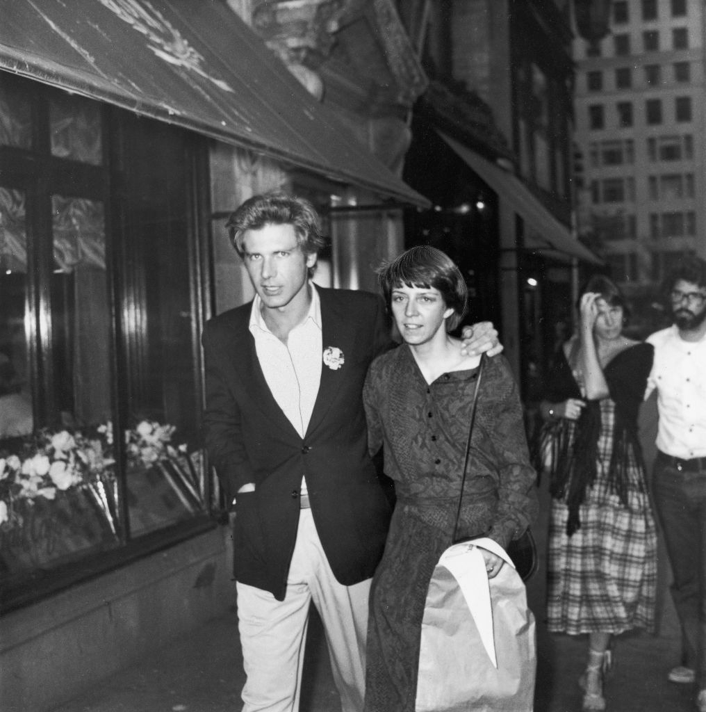 Harrison with his woman walking successful an aged photo