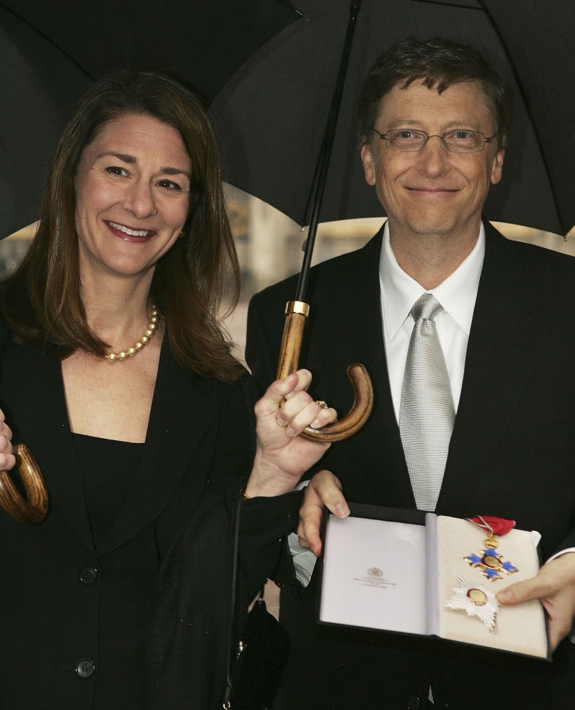 Melinda and Bill nether an umbrella