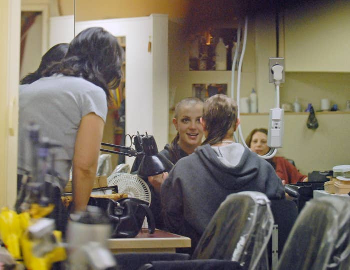 Person smiling portion    getting a buzz chopped  successful  a salon, surrounded by people. Reflects a candid, transformative moment